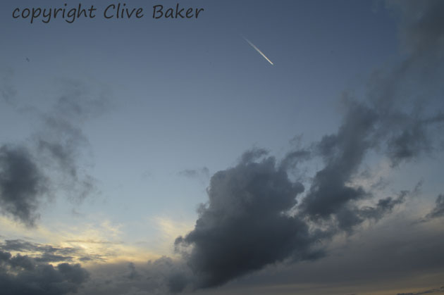 Sunset with airplane vapour trail