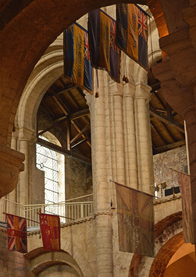 Military flags hang in Ely Cathedral