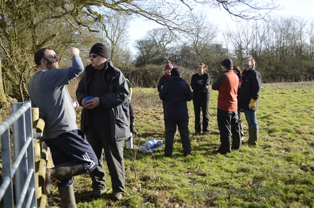 Goupr standing round drinking tea